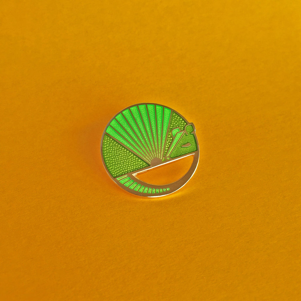 Karmadillo lime green enamel nine-banded armadillo pin finished in gold.