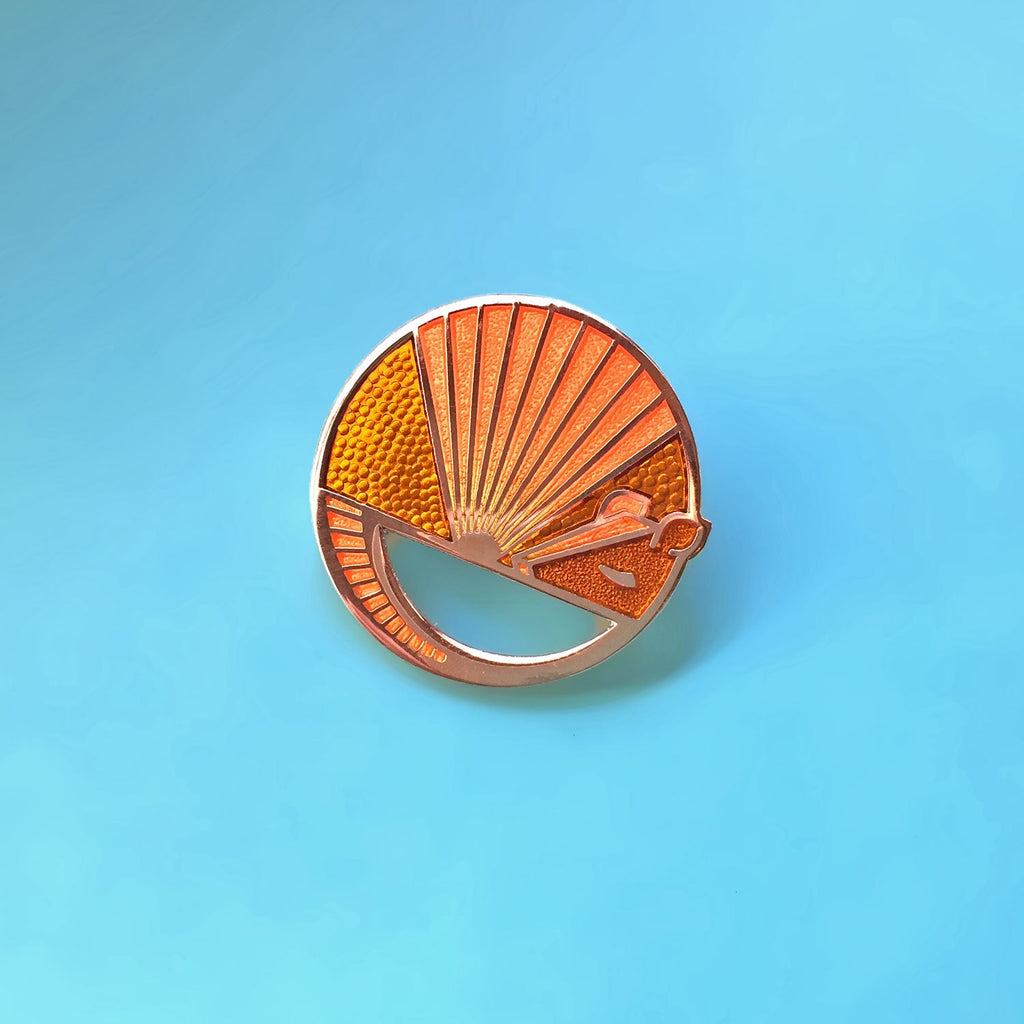 Karmadillo orange enamel nine-banded armadillo pin finished in gold.